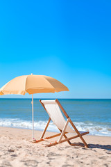 Chair and umbrella on stunning tropical beach background vacation 