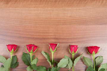 Fototapeta na wymiar red roses on a wooden background