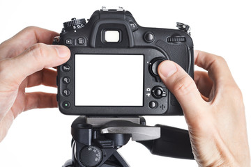 Hands photographer adjust SLR camera isolated