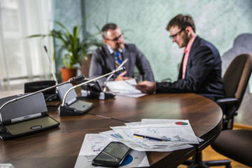 two businessmen talking in office