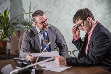 two businessmen talking in office