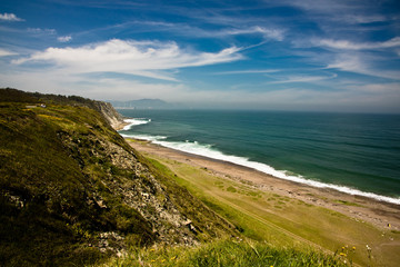 travel to picturesque azkorri beach in springtime, basque country, spain