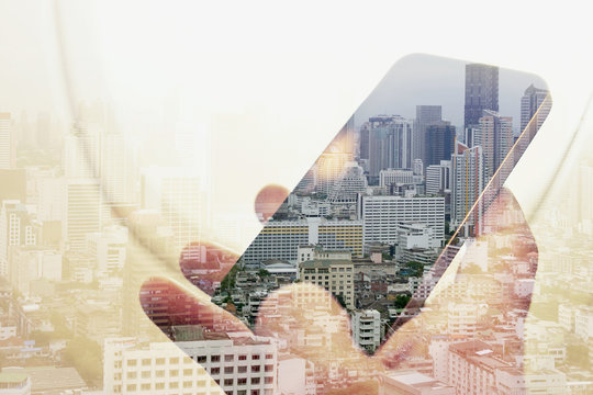 Double exposure image of businessman sitting in the airplane and using smart phone with cityscape background, Business technology concept. - Powered by Adobe