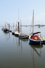 Fototapeta na wymiar Sailing boats in Wells-next-the-sea harbor, Norfolk, England