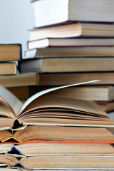 stacks of old opened books, closeup view