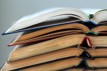 stack of opened old books close-up, horizontal backround