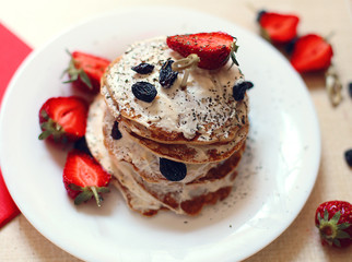 studio photo of breakfast table, sweet pancakes with summer berries  