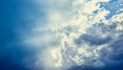 Naklejka na ściany i meble Cloudy sky with sun rays, nature background