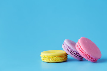 macarons over blue background with room for copy space