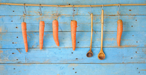 hanging carrots and old wooden spoons, good copy space