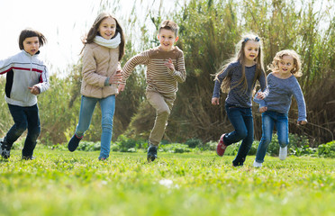 Group of children running in race outdoors