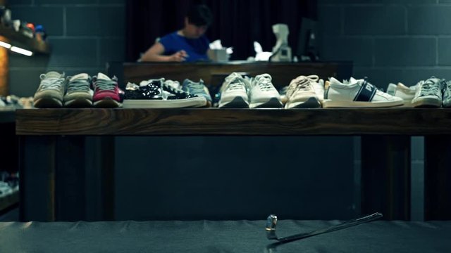 Unrecogrizable shoes shop assistant at work video