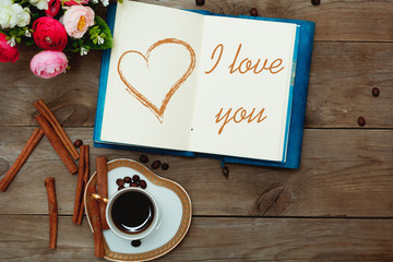 cup of coffee and inscription in notepad: I love you