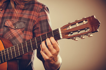 Musicans arm holding strings.