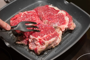 stake from beef on frying pan