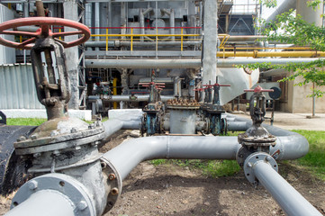 Faucet with steel pipes in natural gas processing plant in summer day