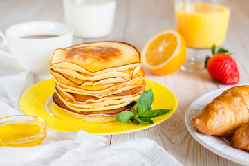 Breakfast with pancakes on a yellow plate
