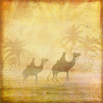 Camel train silhouetted against sky crossing the Sahara Desert
