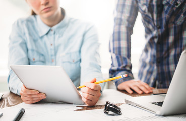 Website developers working using  laptop at the office on wooden