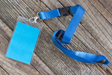 Blank ID card tag on wooden background