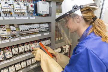 young electrician woman at work
