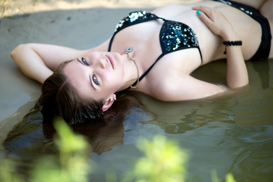 Professional photo of young beautiful girl, lady, model, woman, actress. Sexy, seductive appearance. Rest, river, lake, swimming, relaxing. Perfect body, skin, soft natural makeup. Attractive figure