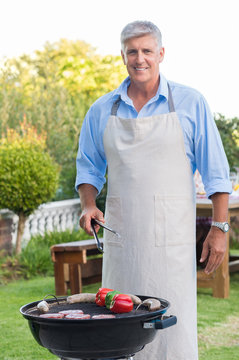 Senior Man Cooking Barbeque