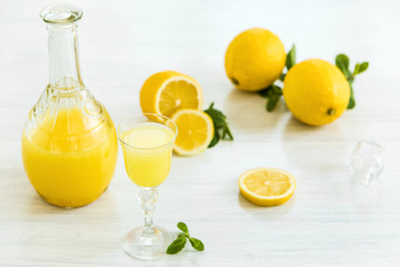 Italian traditional liqueur limoncello with lemon