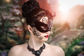 Beautiful young girl in a black mask, magic stranger, the mysterious lady, queen of spades. Hair stuck in spirals on the face. New fantastic world of imagination, dream, desire. Conceptual art make-up - 111782262