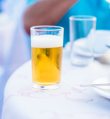 glass of lager beer on the table in the party