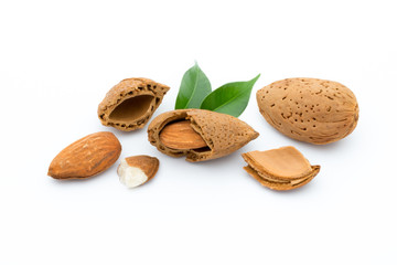Almonds with leaves isolated on white background