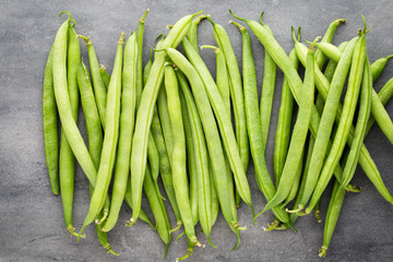 Green beans  on a gray background.
