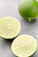 Juicy ripe lime an gray table.