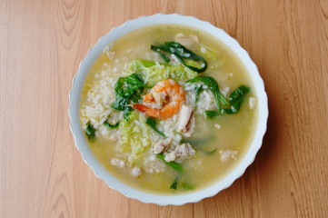 boiled rice with seafood and pork in soup on bowl
