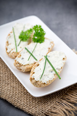 Crispbread with soft cheese with herbs and bacon.