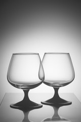 Two empty glasses in white light