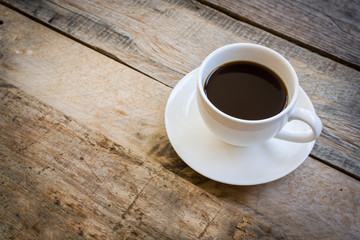 Obraz na płótnie Canvas cup of coffee on wood table background