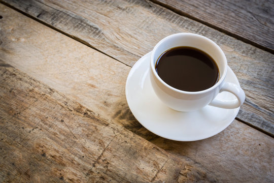 cup of coffee on wood table background