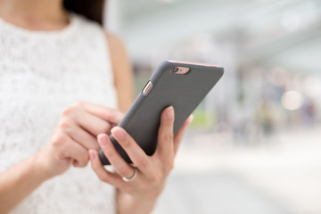 Woman sending sms on mobile phone