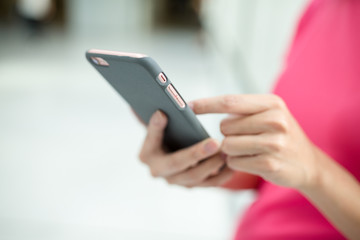 Woman sending sms on cellphone