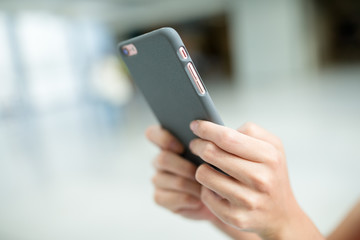 Woman sending sms on mobile phone