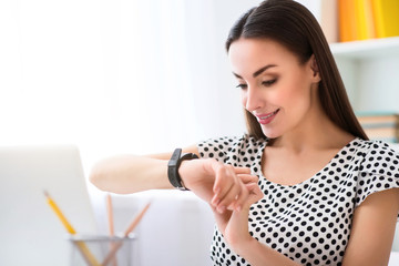 Pleasant woman using smart watch 
