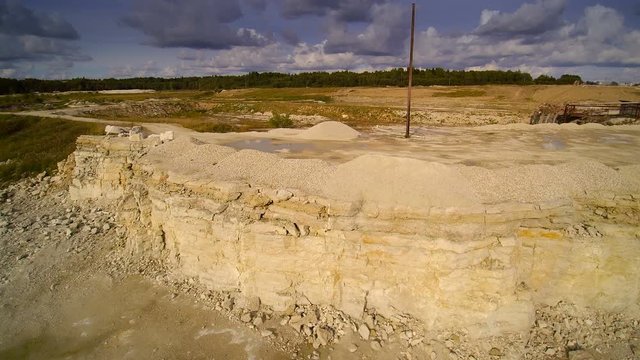 The mountain of limestones in a quarry. Limestone is a sedimentary rock composed largely of the minerals calcite and aragonite