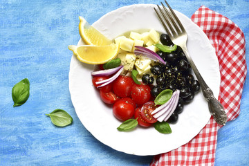 Tomato salad with black olives and mozzarella.