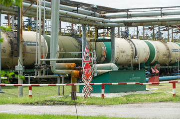 Naklejka premium Old fuel tanks at the oil terminal on railway station on a summer day