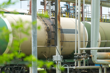 Old fuel tanks at the oil terminal on railway station on a summer day