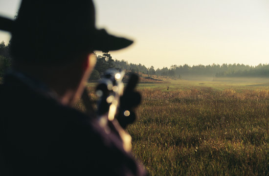Man aiming at animal