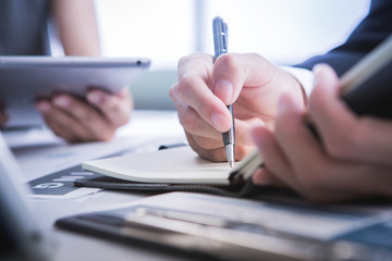 Image of business partners discussing documents and ideas at mee