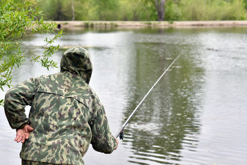Naklejka premium Fisherman with a fishing rod in anticipation of a bite a large trophy