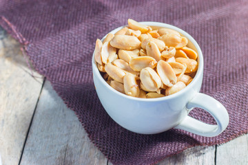 peanuts with salt in white cup